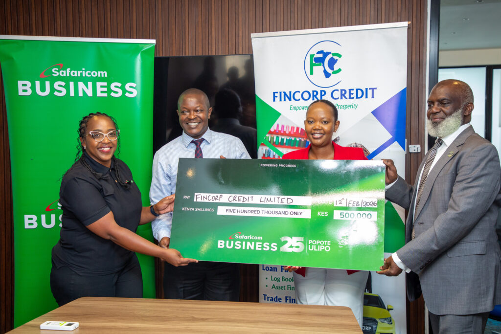 fincorp credit and safaricom business team pose for a photo holding the presentation cheque