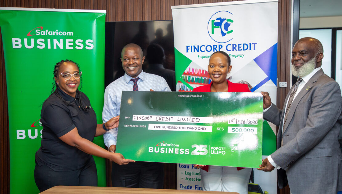 fincorp credit and safaricom business team pose for a photo holding the presentation cheque